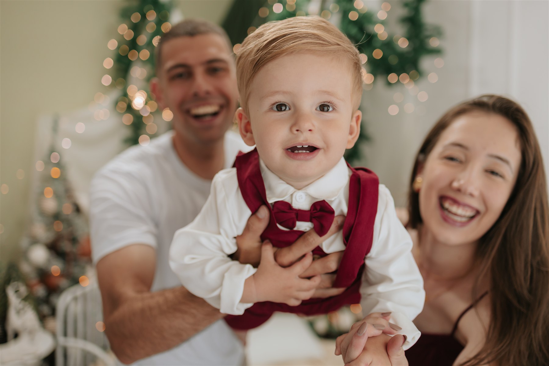 Pais e filho compartilhando um momento alegre no Natal